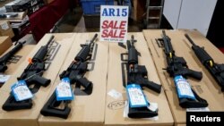 FILE - AR-15 rifles are displayed for sale at a gun show in Pennsylvania, Oct. 6, 2017. 