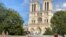 Some enjoy Notre Dame cathedral in Paris, mask-free, despite the city's surging cases. (Lisa Bryant/VOA)