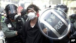 Policajci hapse demonstranta u blizini Politehničkog univerziteta u Hong Kongu, u ponedeljak, 18. novembra 2019.