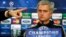 Chelsea's manager Jose Mourinho looks on as the press officer points to a member of the media during a press conference at Stamford Bridge in London, Monday, March 17, 2014. Galatasaray will play Chelsea on Tuesday in their Champions League round of 16 se