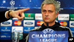 Chelsea's manager Jose Mourinho looks on as the press officer points to a member of the media during a press conference at Stamford Bridge in London, Monday, March 17, 2014. Galatasaray will play Chelsea on Tuesday in their Champions League round of 16 se