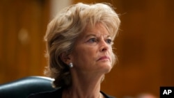 FILE - Sen. Lisa Murkowski, R-Alaska, listens during a Senate Health, Education, Labor, and Pensions Committee hearing to examine COVID-19 on Capitol Hill in Washington, June 23, 2020. 