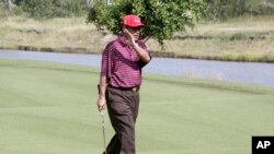 FILE - Cambodian Prime Minister Hun Sen walks on a golf course.