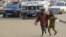 FILE - Two students beg to meet the daily quota imposed by their teacher in a neighborhood of Dakar, Senegal, Aug. 31, 2010. A mobile videogame was created to raise awareness of the tens of thousands of children in Senegal who are forced to beg in the streets by teachers at Koranic schools.
