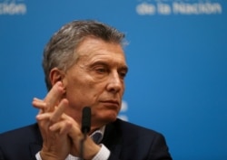 FILE - Argentina's President Mauricio Macri looks on during a news conference after the presidential primaries, in Buenos Aires, Argentina, Aug. 12, 2019.