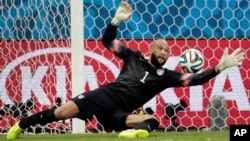 United States' goalkeeper Tim Howard, seen in this July 1, 2014 photo, saves a shot by Belgium during a World Cup round of 16 soccer match at the Arena Fonte Nova in Salvador, Brazil. 