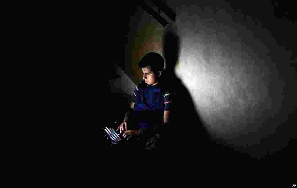 August 22: A member of the media works on a staircase at the Rixos hotel during a power cut in Tripoli. REUTERS/Paul Hackett