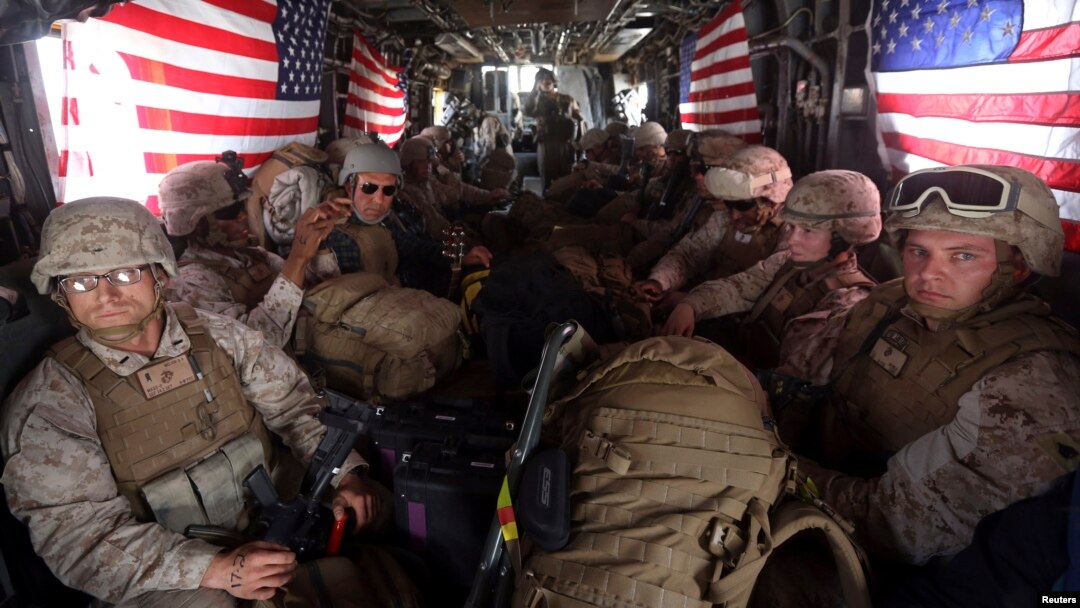 U.S. Marines are seen on board a helicopter at Kandahar air base upon the end of operations for the Marines and British combat troops in Helmand province, Oct. 27, 2014. 