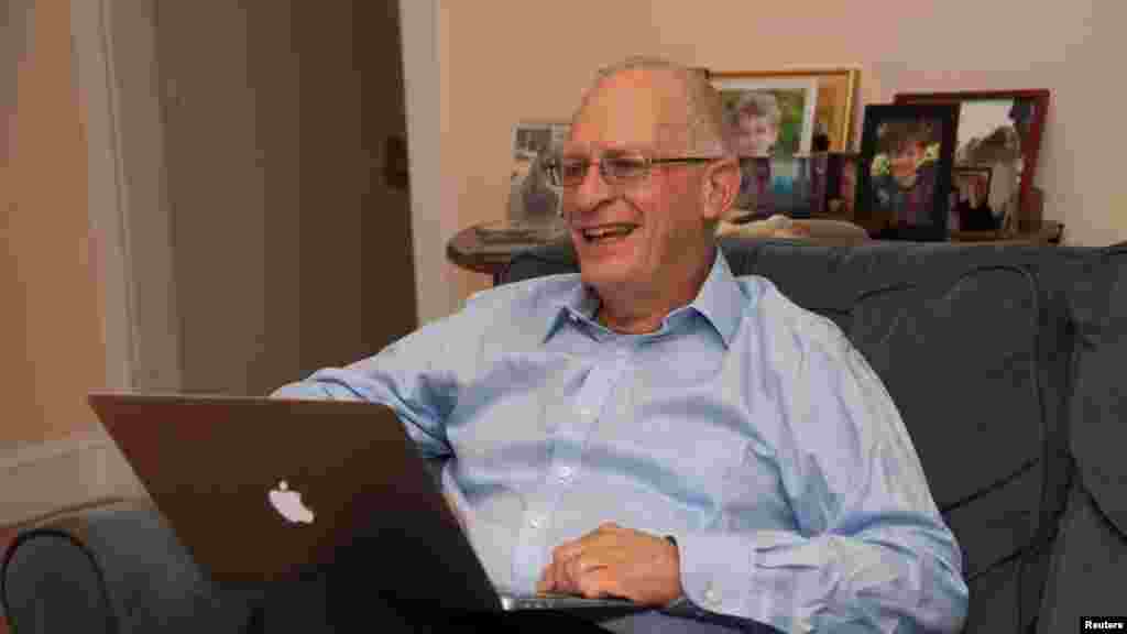 Harvard University professor Oliver Hart reads congratulatory emails after winning the 2016 Nobel Prize for Economics at his home in Lexington, Massachusetts, Oct. 10, 2016. 