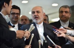 FILE - Iranian Foreign Minister Mohammad Javad Zarif, center, answers questions after a meeting with Japanese Foreign Minister Taro Kono at the foreign ministry in Tokyo, May 16, 2019.