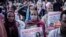 People hold papers showing messages of "No More" as they protest against purported fake news during the send-off ceremony for new military recruits who are joining the Ethiopian National Defence Force in Addis Ababa, Ethiopia, Nov. 24, 2021.
