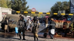 FILE PHOTO: Taliban fighters stand as they hold a checkpoint in Kabul, Afghanistan November 5, 2021. Amnesty says Taliban rule marked by killings, denial of women’s rights.