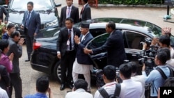 Nepal's Prime Minister K.P. Sharma Oli, center, greets Cambodian government officials upon his arrival at Cambodian National Museum in Phnom Penh, Cambodia, Tuesday, May 14, 2019.