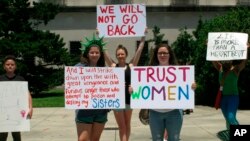 Abortion rights supporters protest at the Louisiana Capitol, where lawmakers were considering a bill that would ban abortion at as early as six weeks of pregnancy, May 21, 2019, in Baton Rouge, La. The bill won final legislative passage May 29. 