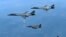 FILE - In this June 20, 2017, file photo provided by South Korean Defense Ministry, U.S. Air Force B-1B bombers, top, and second from top, and South Korean fighter jets F-15K fly over the Korean Peninsula, South Korea. A South Korean lawmaker said Oct. 10, 2017, that North Korean hackers may have stolen highly classified military documents that include U.S.-South Korean wartime "decapitation strike" plans against the North.