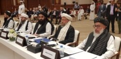 Members of the Taliban political office are seen inside the conference hall at the start of the intra-Afghan dialogue. Sitting far right is Sher Mohammad Abbas Stanekzai, head of the Taliban delegation, in Doha, Qatar, July 7, 2019.