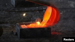 Molten rare earth metal Lanthanum is poured into a mould at Jinyuan Company's smelting workshop near the town of Damao in China's Inner Mongolia Autonomous Region