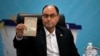 Vahid Haghanian, a former commander in the Revolutionary Guards, shows his identification document to the media while registering his name as a candidate for the June 28 presidential election at the Interior Ministry in Tehran, Iran, on June 1, 2024.