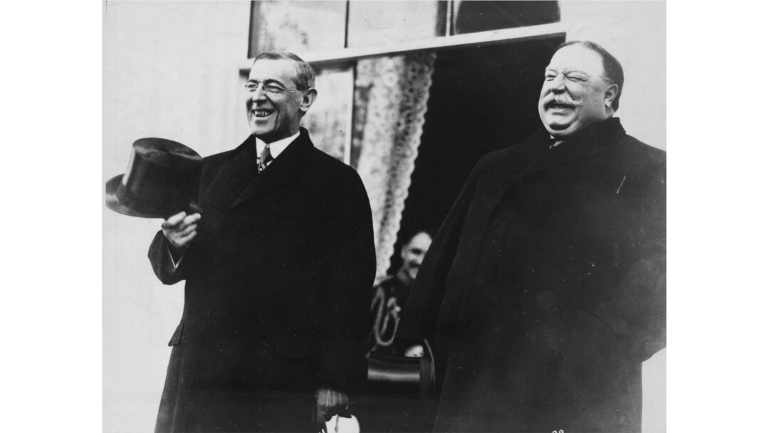 FILE - President-elect Woodrow Wilson and President William Howard Taft laugh on the White House steps before departing together for Wilson's inauguration in Washington, D.C., U.S. in March 1913.