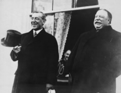 FILE - President-elect Woodrow Wilson and President William Howard Taft laugh on the White House steps before departing together for Wilson's inauguration in Washington, D.C., U.S. in March 1913.
