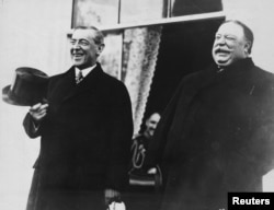 FILE - President-elect Woodrow Wilson and President William Howard Taft laugh on the White House steps before departing together for Wilson's inauguration in Washington, D.C., U.S. in March 1913.