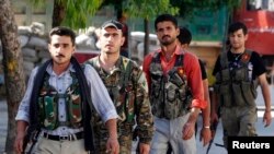 FILE - Kurdish fighters from the Popular Protection Units (YPG).