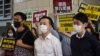 FILE - Pro-democracy lawmakers, from left; Eddie Chu, Raymond Chan and Ted Hui walk with supporters at a local court in Hong Kong, Nov. 19, 2020.