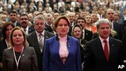 FILE - Meral Aksener, a former interior minister and deputy parliament speaker, center, attends her party's first meeting in Ankara, Turkey, Oct. 25, 2017. 