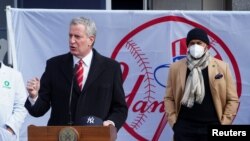 New York's Mayor Bill de Blasio speaks next to former New York Yankees pitcher Mariano Rivera at a mass vaccination site at Yankee Stadium amid the coronavirus disease (COVID-19) pandemic in the Bronx borough of New York City, Feb. 5, 2021.