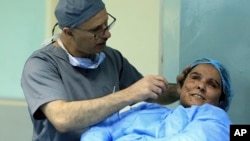 Plastic surgeon Dr. Abbas al-Sahan makes surgical marks around the damaged ear of Saja Ahmed Saleem, before her reconstructive surgery in Baghdad, Iraq, Nov. 6, 2018. 