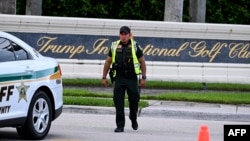 A sheriff's deputy blocks the street outside the Trump International Golf Club in West Palm Beach, Florida, on Sept. 15, 2024.