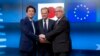 European Commission President Jean-Claude Juncker, right, European Council President Donald Tusk, center, greet Japanese Prime Minister Shinzo Abe prior to a meeting at the Europa building in Brussels on Tuesday, March 21, 2017.