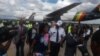 Bona Mugabe Chikore and her husband, Simba Chikore, at the Robert Gabriel Mugabe International Airport on Wednesday.