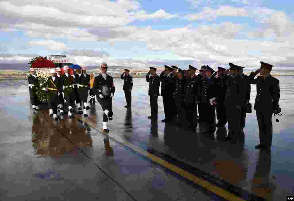 A picture released by Turkish army press office shows Turkish soldiers carrying the coffin of Russian pilot Lt. Col. Oleg Peshkov into a Russian Air Force transport during a ceremony at Esenboga Airport in Ankara. Ankara sent back to Russia the body of a pilot killed when his plane was shot down by the Turkish air force for allegedly violating its air space on the Syrian border.