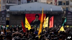 Hezbollah supporters listen to their leader Sayyed Hassan Nasrallah as he speaks via a video link during Ashoura, the Shiite Muslim commemoration marking the death of Immam Hussein, the grandson of the Prophet Muhammad, at the Battle of Karbala in…