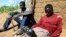 FILE - Zimbabweans listen to a radio for an announcement of election results in Umguza, Apr. 1, 2008. 