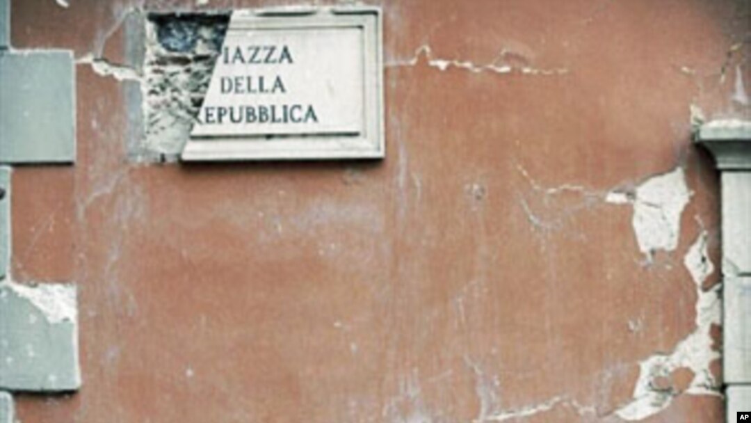 Rubble lies on the ground beside a postbox in the Piazza della Repubblica in Central L'aquila (January 2010 file photo)