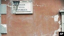 Rubble lies on the ground beside a postbox in the Piazza della Repubblica in Central L'aquila (January 2010 file photo)