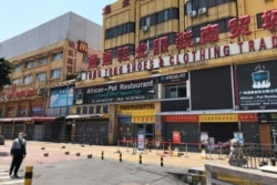 FILE - An African restaurant is closed along with other businesses in Guangzhou's Sanyuanli area, where a neighborhood is in lockdown after several people tested positive for the coronavirus, in Guangdong province, China, April 13, 2020.