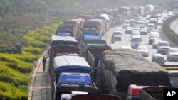 Vehicles line up for diesel near a gas station in Kunming, Yunnan province, China. Controlling soot from trucks, cars, planes, boats and wood and dung fires can have an immediate impact on climate change.