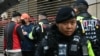 Police question a man outside the West Kowloon Magistrates' court in Hong Kong on November 20, 2024. 