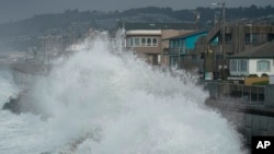 FILE - Large waves crash into a seawall in Pacifica, Calif., on Jan. 6, 2023. New data permits researchers to follow the growth of big waves over 90 years. (AP Photo/Jeff Chiu, File)