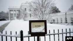 The White House is seen during a winter storm on the 23rd day of the U.S. government shutdown, Jan. 13, 2019, in Washington. 