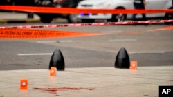 Evidence tent markers mark the crime scene where Argentine lawmaker Hector Olivares was seriously injured and another man was killed after they were shot at from a parked car near the Congress building in Buenos Aires, Argentina, May 9, 2019.