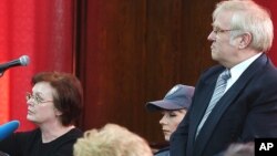 Janina Chim, left, and Grzegorz Zemek, right, defendants, along with Dariusz Przywieczerski, in Poland's biggest mismanagement and embezzlement trial, hear the court verdict, March 29, 2005 in Warsaw, Poland. Chim and Zemek were sentenced to six and nine years on charges of misappropriating funds from a fund that Poland's last communist government set up in 1989 to buy back the nation's foreign debt. 