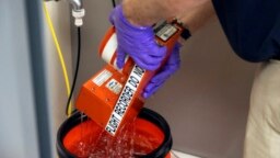 In this image provided by the National Transportation Safety Board, NTSB investigators examine the flight data recorder in Washington, Jan. 30, 2025, recovered from the jet that crashed with a helicopter near Ronald Reagan Washington National Airport.