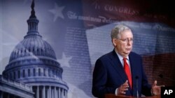 FILE - Senate Majority Leader Mitch McConnell of Ky., speaks with reporters after the Senate approved a nearly $500 billion coronavirus aid bill, April 21, 2020, on Capitol Hill in Washington.