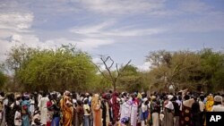 Women line up for food distribution in a makeshift camp for internally displaced people in the village of Mayen Abun, southern Sudan, May 26, 2011