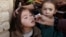 A girl receives polio vaccine drops from a vaccination worker outside her family's home in Quetta, Pakistan, Jan. 2, 2017.