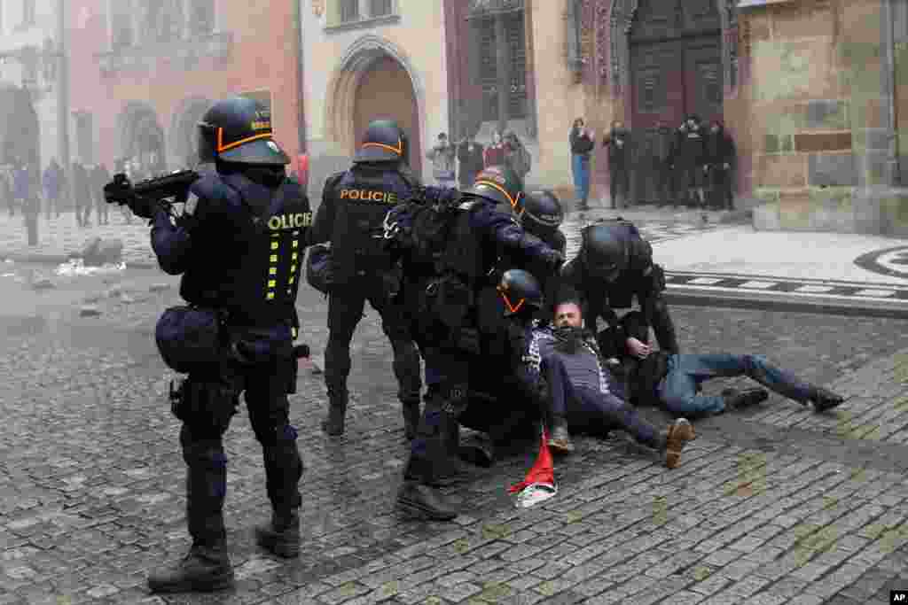 A demonstrator is detained during protest against the COVID-19 restrictive measures at Old Town Square in Prague, Czech Republic.